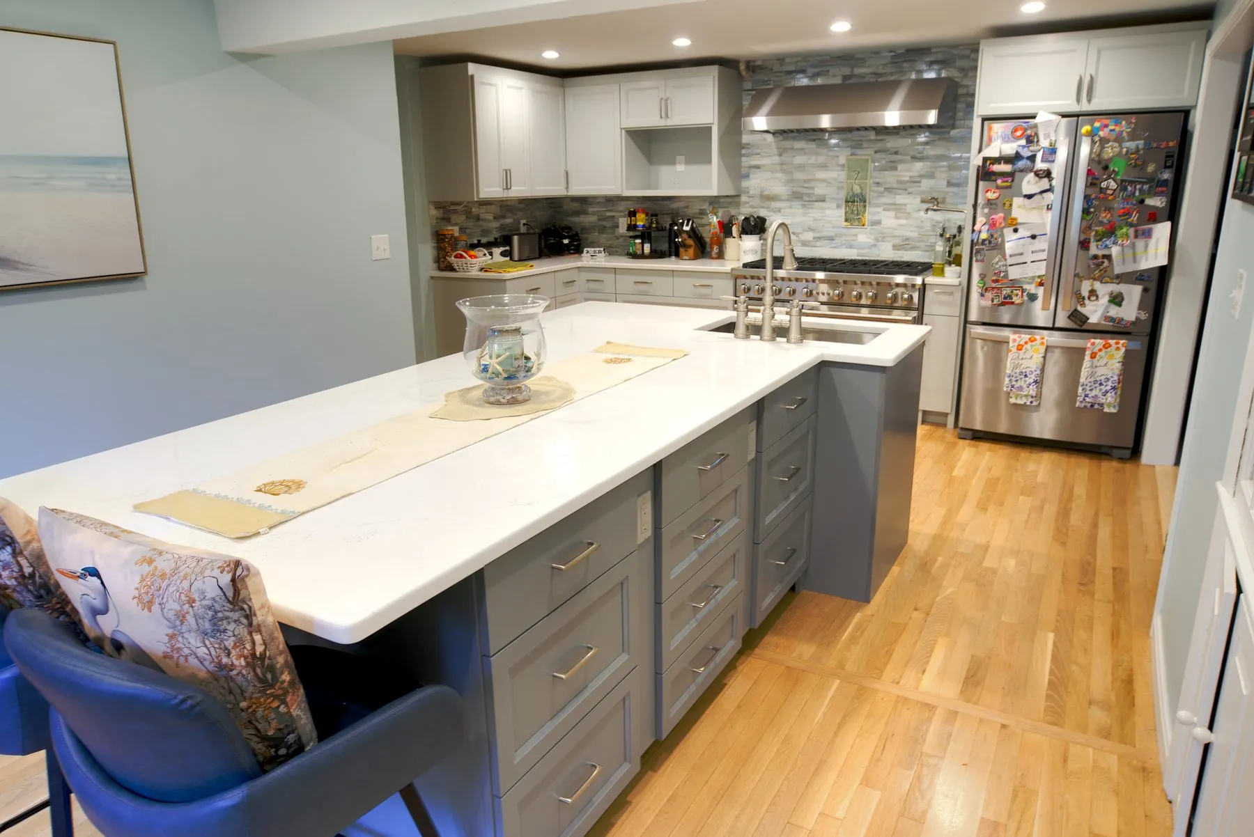 Newly installed kitchen with quartz peninsula and grey shaker cabinetry