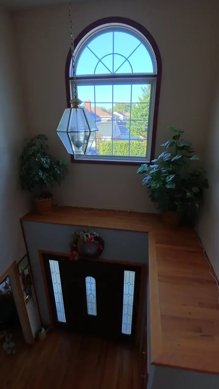 Indoor drone tour rising through a two story foyer