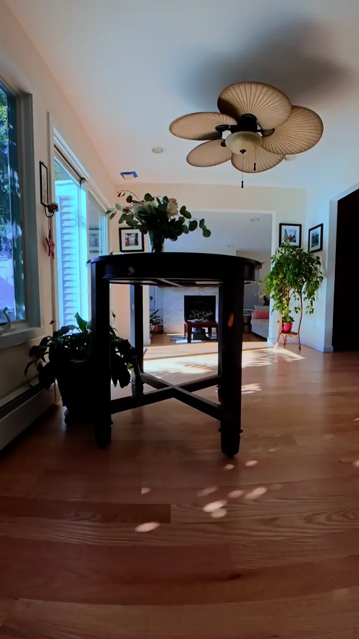 Indoor drone tour flying under a table into a living room